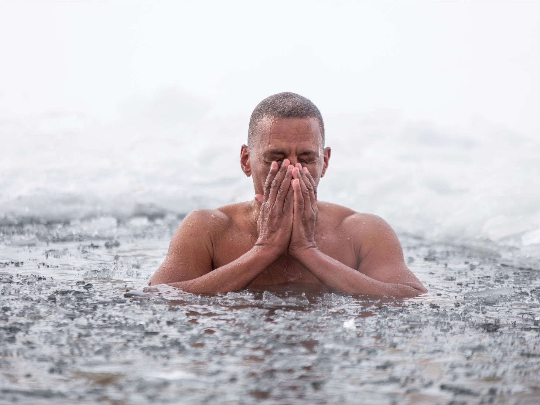 Person immersed in ice-cold water practicing Wim Hof's method