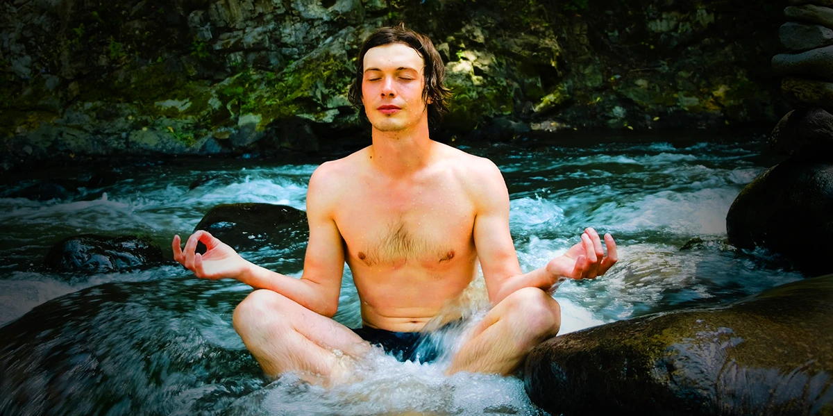 Person practicing Wim Hof breathing technique in a tranquil environment